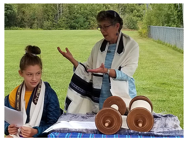 Rabbi Suri officiating a teen girl's Bat Mitzvah ceremony outdoors